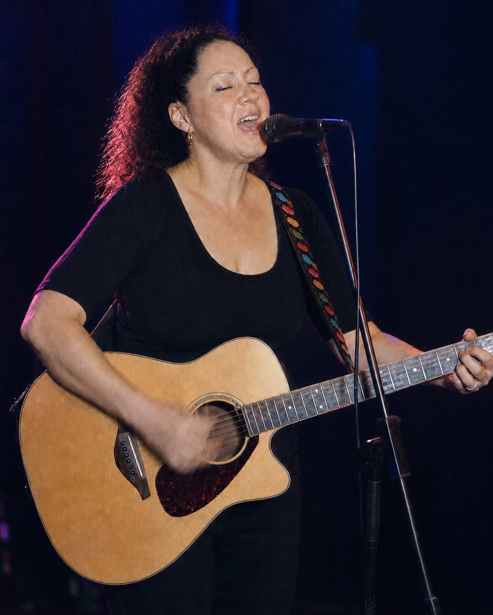 Bobbyjo singing on stage with her acoustic guitar